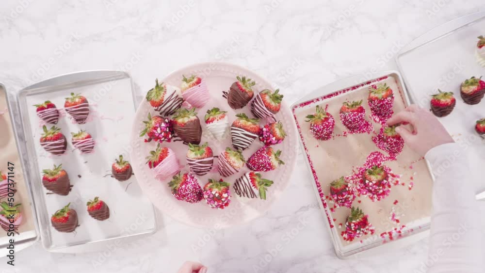 Sticker flat lay. step by step. arranging a variety of chocolate dipped strawberries on a pink cake stand.