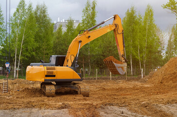 An excavator is digging a pit for a house.