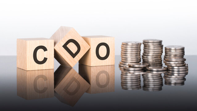 cdo - text is made up of letters on wooden cubes lying on a mirror surface