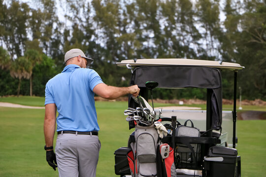A golfer picking out a club
