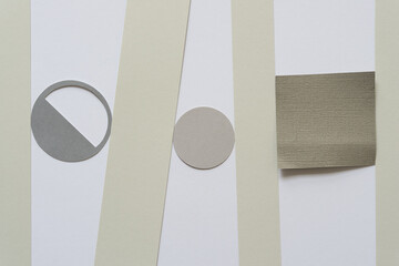 paper pieces on a flat paper surface (letter o, circle, square, stripes)