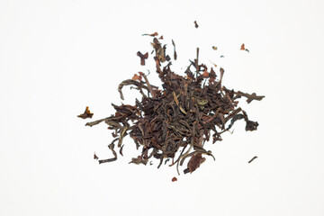 Black leaf tea on white background, top view.