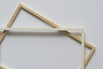 two wooden frames (one painted white) on a light background