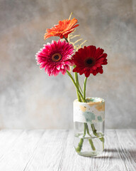 Handmade concrete and glass vase. Flower in a vase. Scandinavian interior.