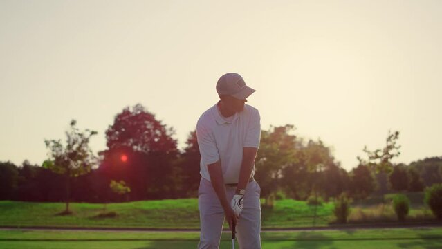 Golf player teeing club putter on sport training. Rich man on luxury vacation.