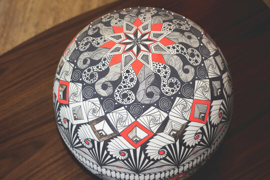 Hand painted ceramic sphere with abstract symbols