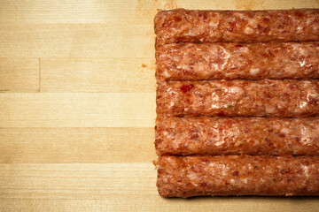Minced meat with seasoning on a wooden board, photo indoors