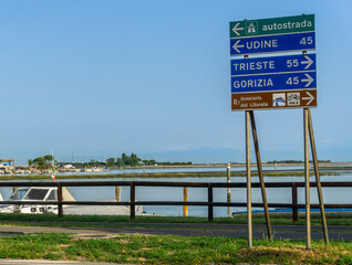 Fototapeta premium Road signs with different names of Italian towns, roads are leading in the different directions