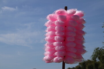 Pink cotton candy individually packed in plastic bags and ready to sell to passersby