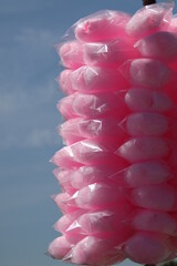 Pink cotton candy individually packed in plastic bags and ready to sell to passersby