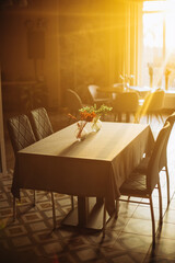 Interior of a cozy restaurant , reserved table with sunlight
