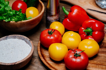 a wooden bowl of flour, spices and vegetables on the kitchen table