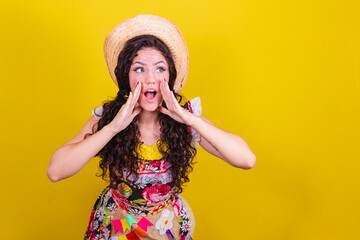 Beautiful woman dressed in typical clothes for a Festa Junina. shouting, calling, saying loud...