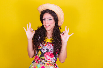 Beautiful woman dressed in typical clothes for a Festa Junina. Finger ok sign, yes.