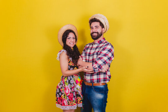 Beautiful Couple Dressed In Typical Clothes For A Festa Junina. Arraia De Sao Joao. With Arms Crossed
