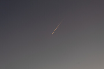 Trail of the passing of a small plane in the dark sky
