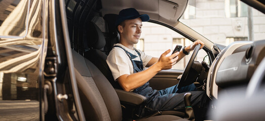 The driver in the uniform of the courier company fast delivery of goods to the address.