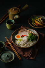 Asian noodle soup on table, ramen with pork, vegetables and egg in a bowl. Copy space - 507380774