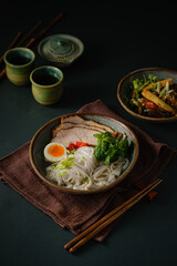 Asian noodle soup on table, ramen with pork, vegetables and egg in a bowl. Copy space - 507380915