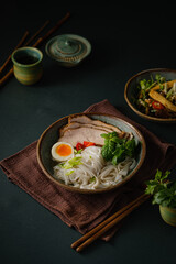 Asian noodle soup on table, ramen with pork, vegetables and egg in a bowl. Copy space - 507380957