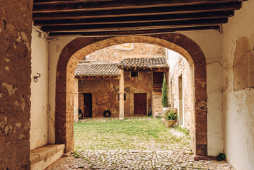 Naklejka premium Old Spanish courtyard. Arch. City of Valldemossa