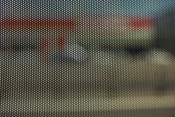 Film on glass of mesh texture. Advertising film from inside interior of bus.