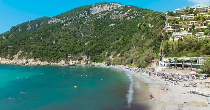 Aerial day Time lapse of people relaxing and swimming at Ermones beach bay, Corfu, Greece