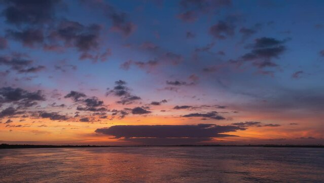 Time lapse of a vibrant colorful pastel sky after a sunset over a bay. Jones Beach - Long Island, New York