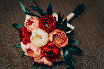 Handmade wedding bouquet from a satin ribbon. The bouquet contains red and white roses. Wedding, holiday - obrazy, fototapety, plakaty