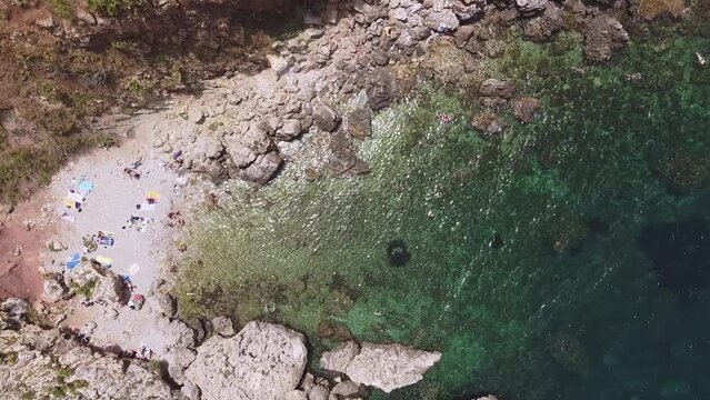 Aerial drone view above the beautiful coastline, turquoise clear sea water and wild nature of Zingaro Nature Reserve, Sicily. Tropical travel holiday destination in Europe near Scopello in Italy.