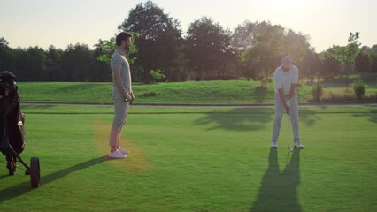 Golfing team play sport on course. Golf group practicing hits in country club.