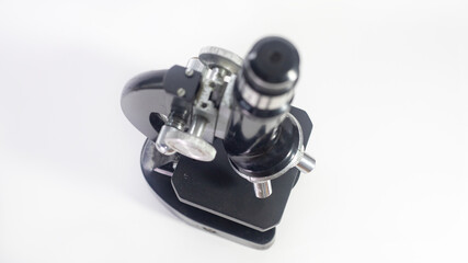 old analog microscope, mirror on white background with copy space