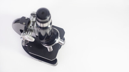 old analog microscope, mirror on white background with copy space