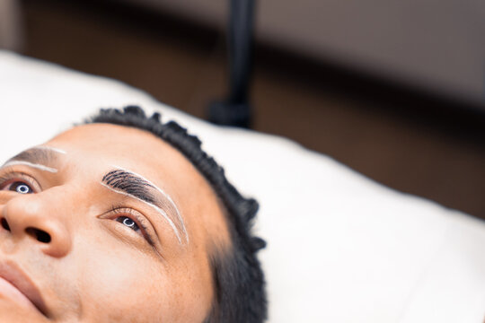 closeup of a man during a microblading procedure