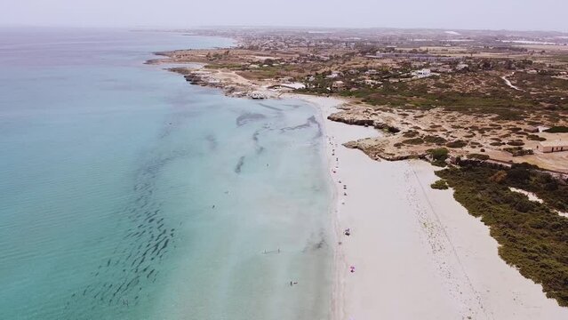 Aerial drone. Beautiful crystal clear water and sandy beach. Cittadella dei Maccari, San Lorenzo, Nature Reserve Oasis of Vendicari, Sicily. Idyllic holiday destination near Noto and Marzamemi.