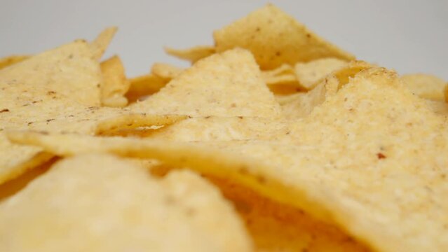 MACRO: Motion over potato chips on a white background, Dolly shot