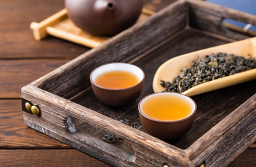 cup of tea and teapot on wooden table