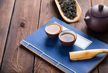 cup of tea and teapot on wooden table