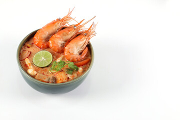 Tom yum kung spicy. Tom Yum kung in a green bowl on a white background, copy space.