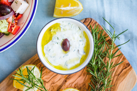 Typical Greek snack consisting of tzatziki sauce with cucumber, olives and bread
