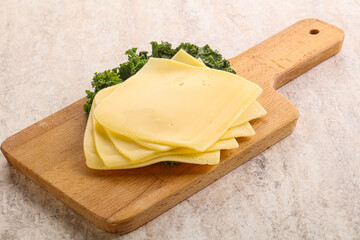 Sliced Gouda cheese over board