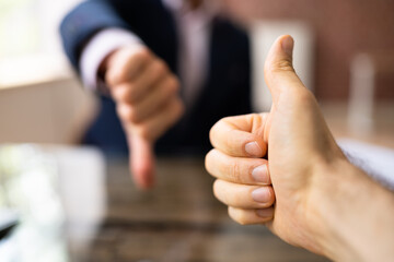 Two Business People Showing Thumbs Up And Thumbs Down Sign