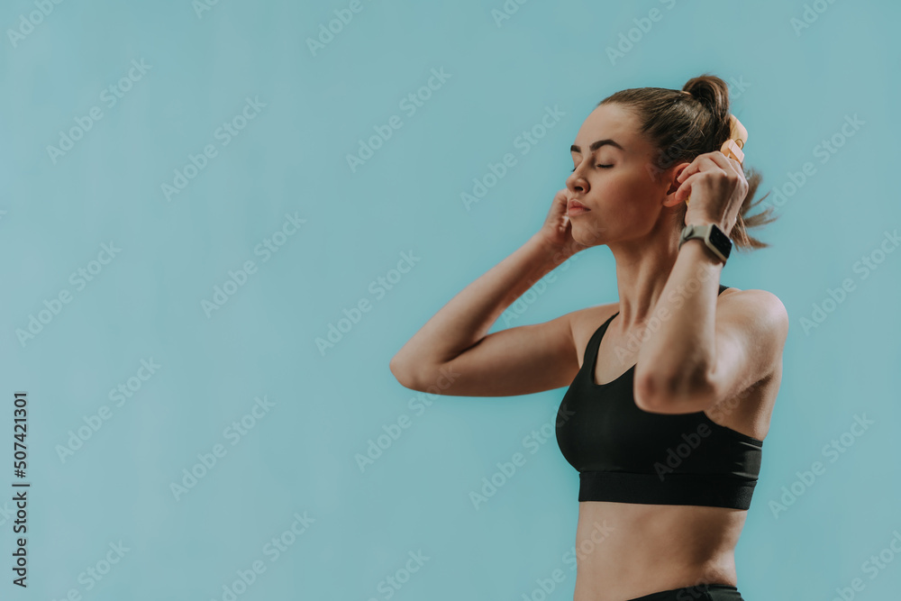 Sticker Fitness woman relaxing and listening music during her workout over green background.