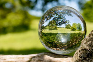 Photograhing a crystalball with nature inside in Scandinavia in springtime. It shows how to be inspired in innovation processes by nature.