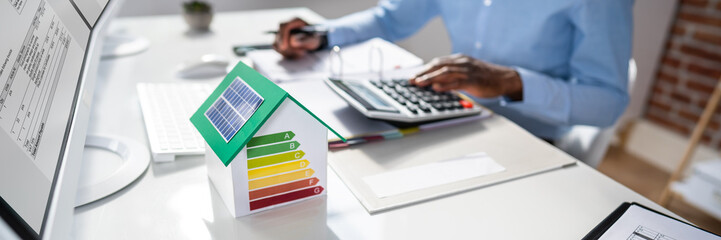 Businessman Calculating House Energy Cost