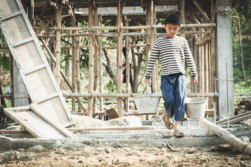 Children working at construction sites are forced to work. The concept of anti-child labor. The...
