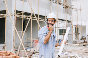 Hispanic Latin foreman engineer builder enjoy working radio command in home construction site happy...