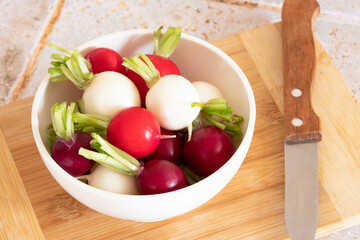 top view of tricolor radishes in a bowl on a table