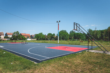 new outdoor basketball court with rubber surface