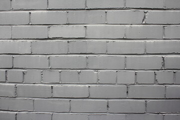 Grey dry brick wall with cement seams.